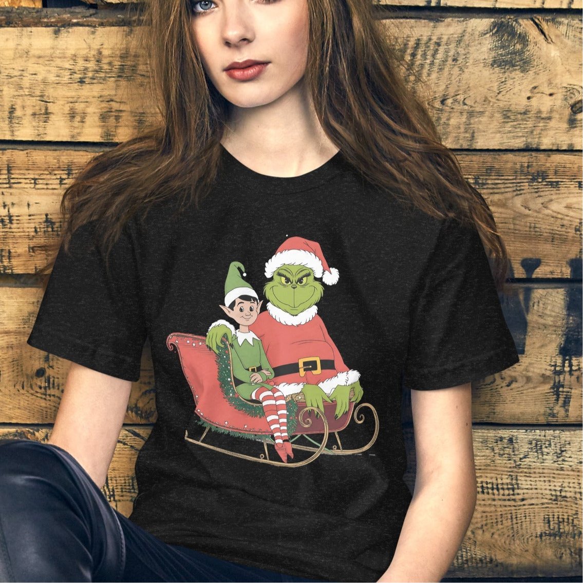 Women’s Holiday T-Shirt – Grumpy Grinch and Playful Elf on Sleigh - Sublimegifts4u.com